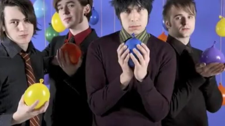 the members of action action holding tiny balloons??
