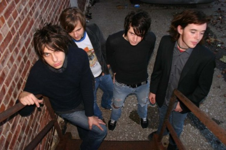 the members of action action standing around on a staircase